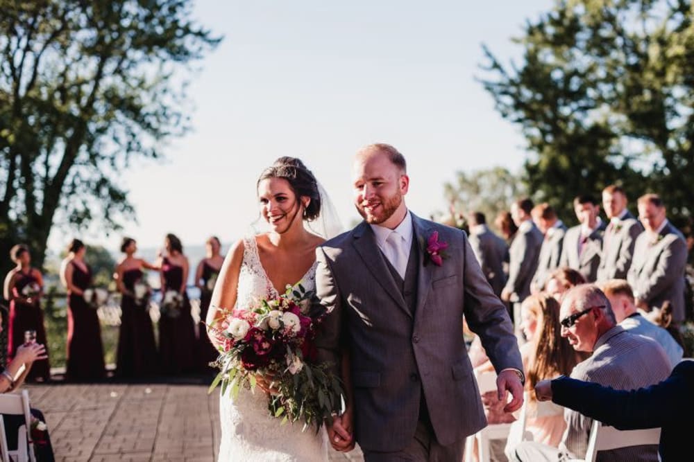 Bride and groom walking down the aisle at The Whitcomb Senior Living Tower in St. Joseph, Michigan