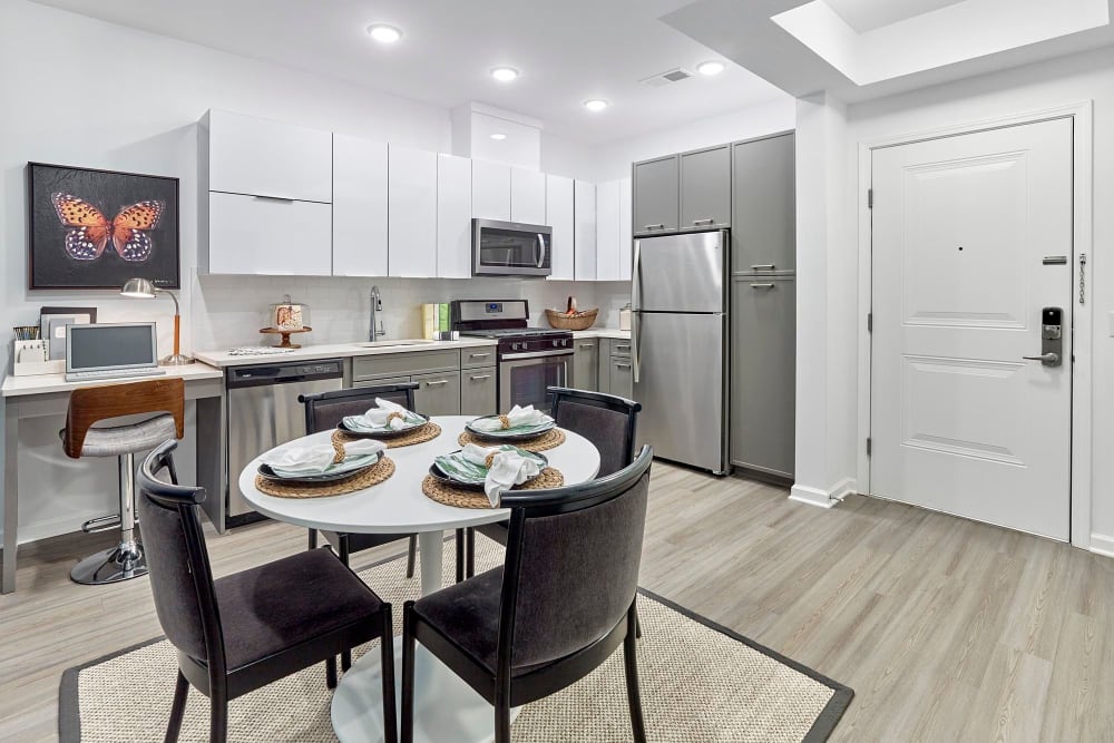 Kitchen with appliance and dining table at The Grande at MetroPark in Woodbridge, New Jersey