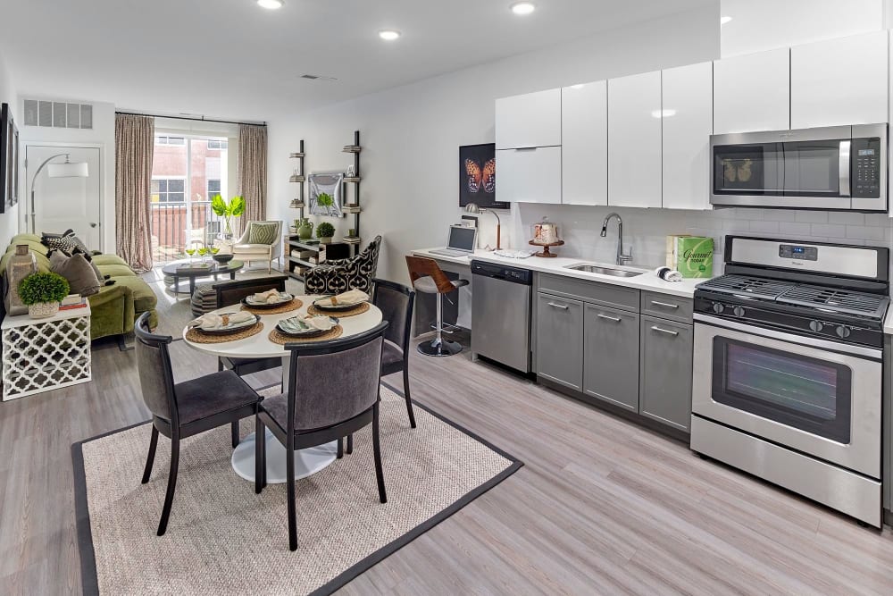 Model kitchen with cabinets and dining table at The Grande at MetroPark, Woodbridge, New Jersey