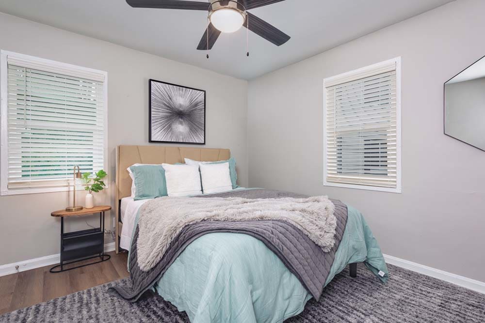 Model bedroom with ceiling fan at Alcove at Seahurst in Burien, Washington