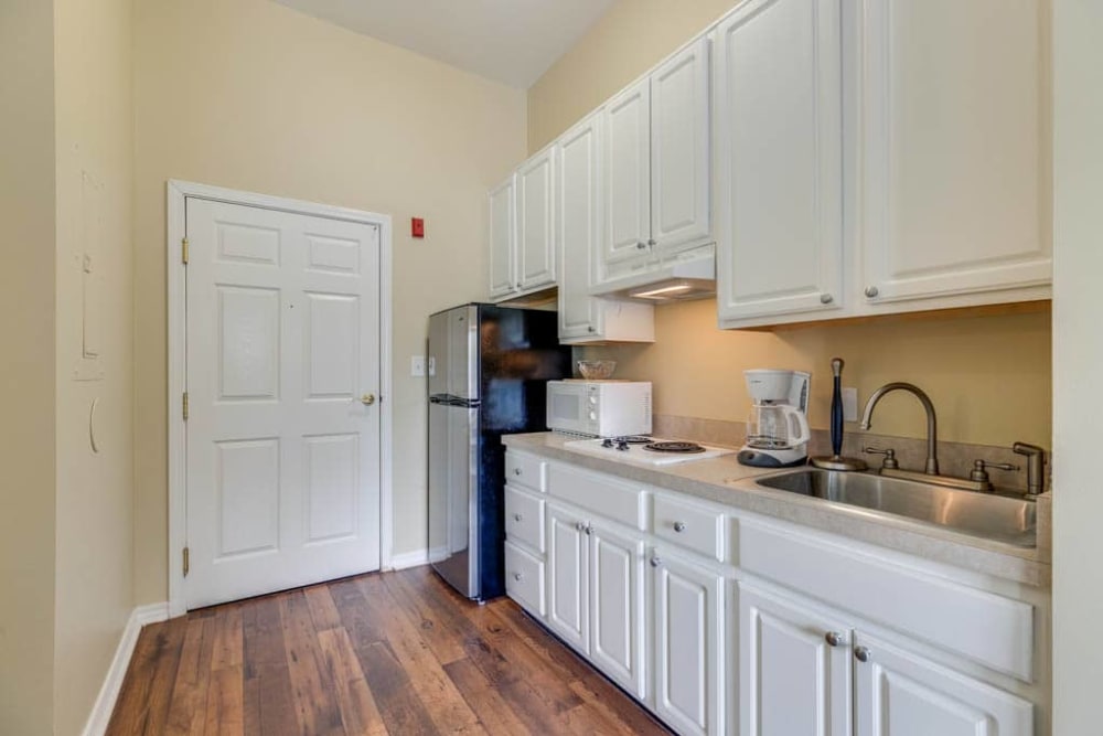 Model kitchen with hardwood floors at Arcadia Senior Living Louisville in Louisville, Kentucky