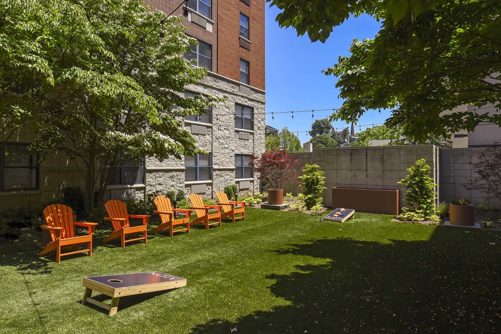 Outdoor space with cornhole and lounge chairs at The Monroe, Morristown, New Jersey