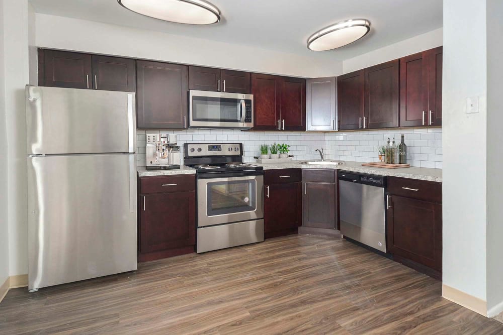 Kitchen with stainless-steel appliances and plank flooring at River Pointe in Bethlehem, Pennsylvania