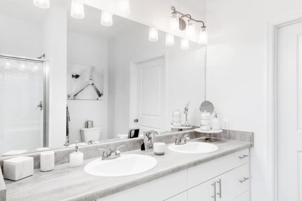 Model bathroom with dual sinks at Capital Crest at Godley Station in Savannah, Georgia