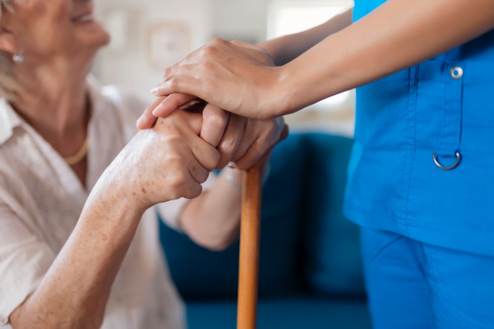 Nurse holding resients hands at Vista Prairie at Goldfinch Estates in Fairmont, Minnesota