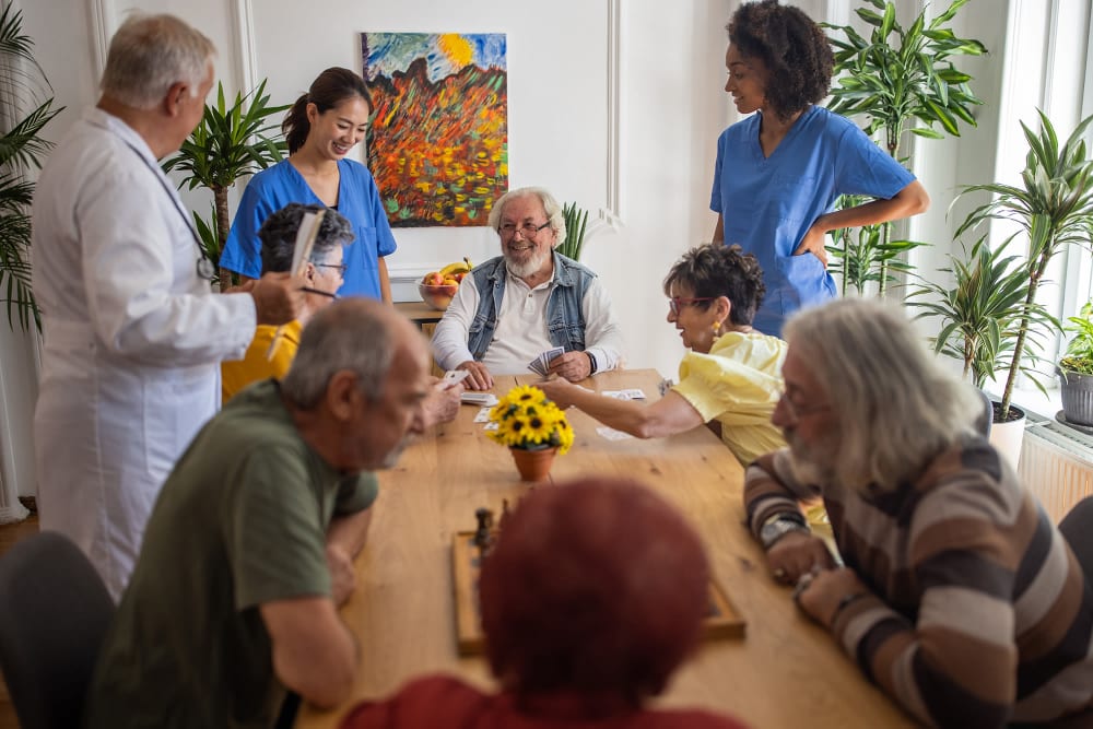 Staff and doctor talking with clients at Vista Prairie at Garnette Gardens in Redwood Falls, Minnesota