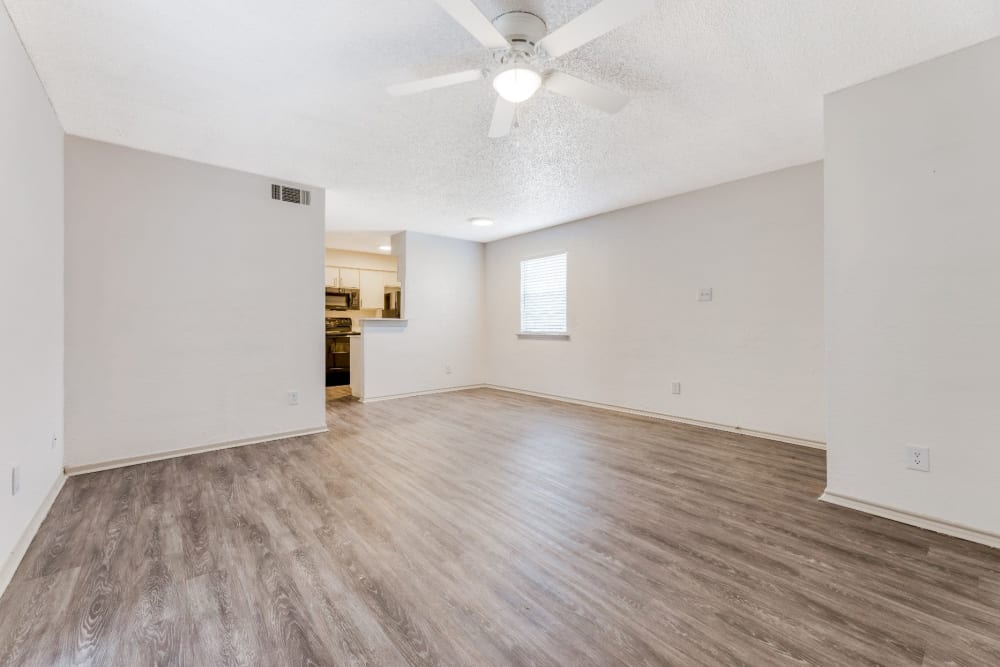 Unfurnished living area with ceiling fan and hardwood floors at Marshall Apartment Homes in Balch Springs, Texas