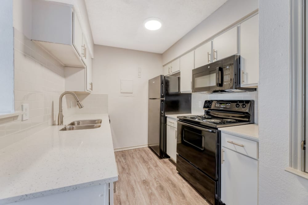 Kitchen with white counter at Marshall Apartment Homes in Balch Springs, Texas