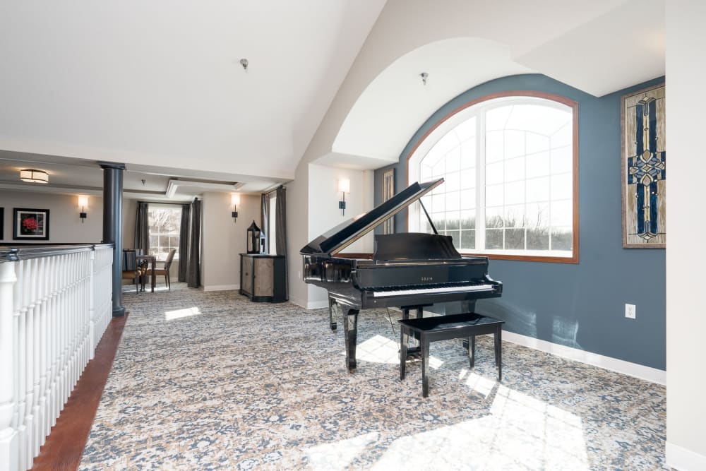 Foyer with grand piano at Vista Prairie at Copperleaf in Willmar, Minnesota