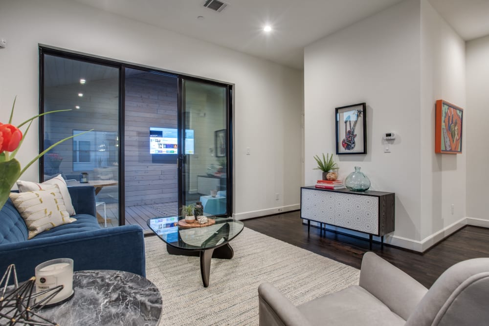 Apartment living room with sliding glass doors at The Collection Townhomes in Dallas, Texas