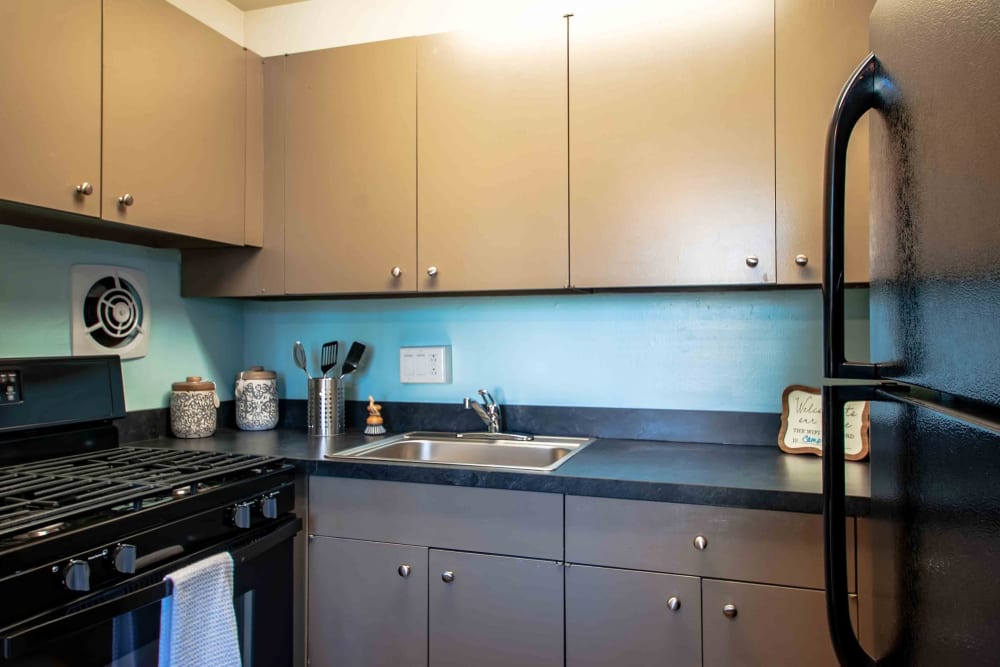 Kitchen with wood grain cabinets at Camp Hill Plaza Apartment Homes in Camp Hill, Pennsylvania