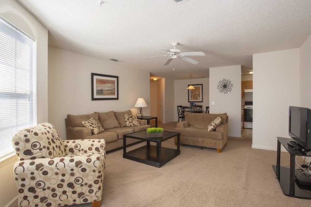 Carpeted model living room at Forest Pointe in Walterboro, South Carolina