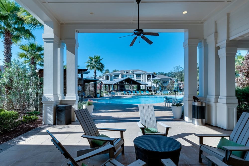 Outdoor lounge chairs near the pool at Parc at Broad River | Apartments in Beaufort, South Carolina