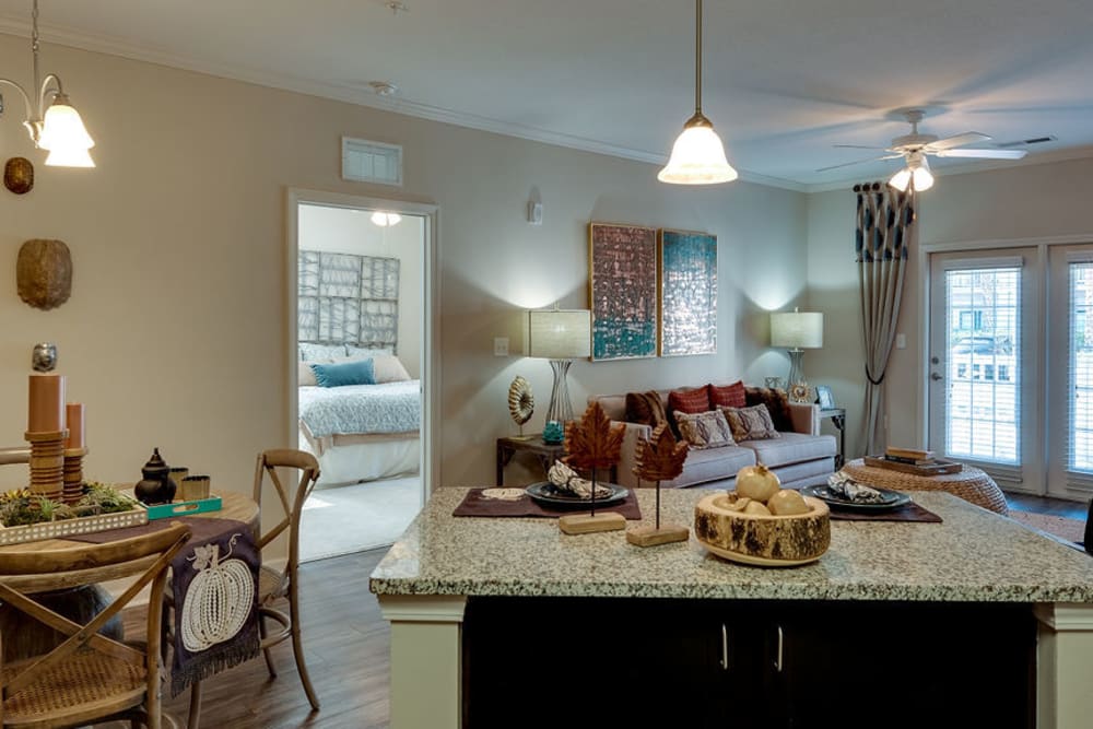 Kitchen island, dining nook, and living room at Parc at Broad River | Apartments in Beaufort, South Carolina