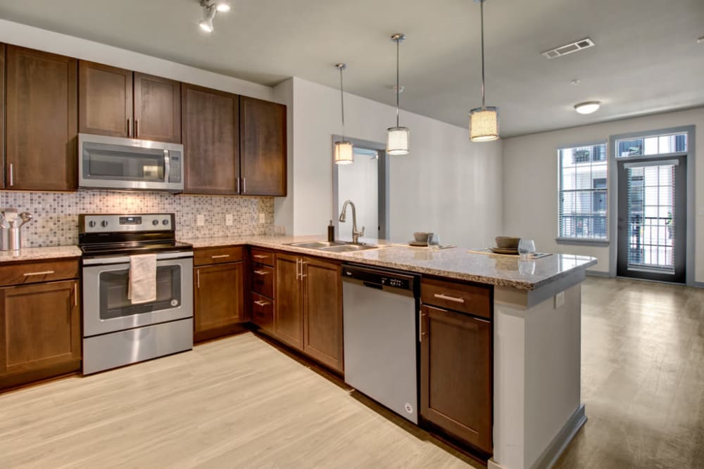 Kitchen and living room at Duet | Apartments in Nashville, Tennessee
