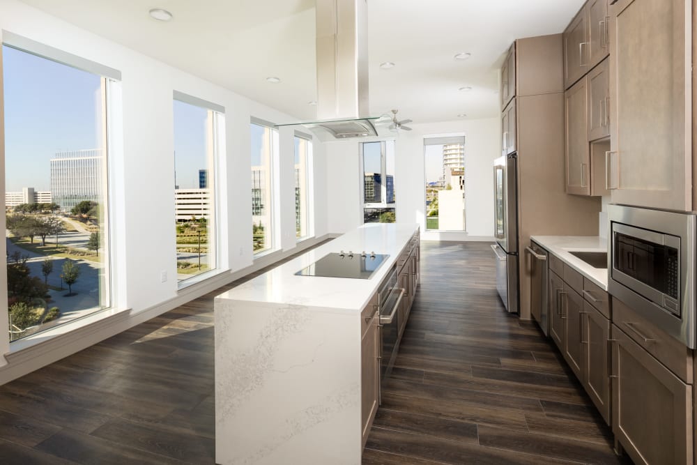 Modern kitchen with floor to ceiling windows at Instrata at Legacy West in Plano, Texas