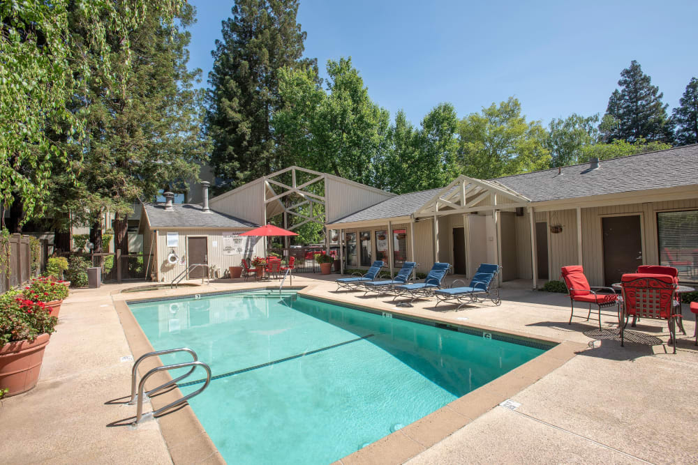 Swimming pool area at Huntcliffe Apartments in Fair Oaks, California