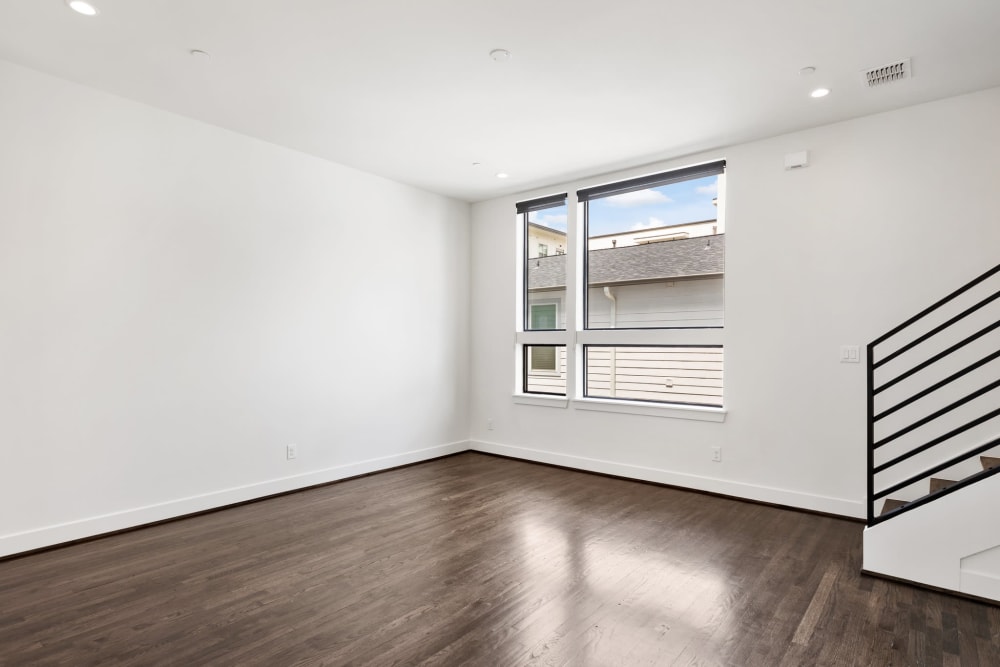 Spacious living room with hardwood floors at The Collection Townhomes in Dallas, Texas