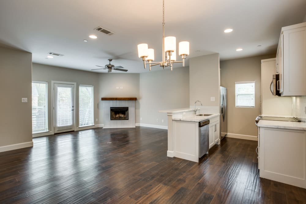 Open concept floor plan with kitchen and living room with fireplace at The Collection Townhomes in Dallas, Texas