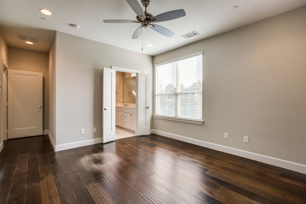Spacious living room with dark hardwood floors at The Collection Townhomes in Dallas, Texas