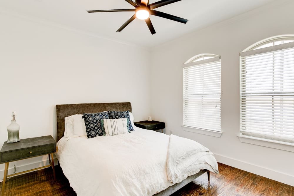 Bedroom with multiple windows and ceiling fan at The Collection Townhomes in Dallas, Texas