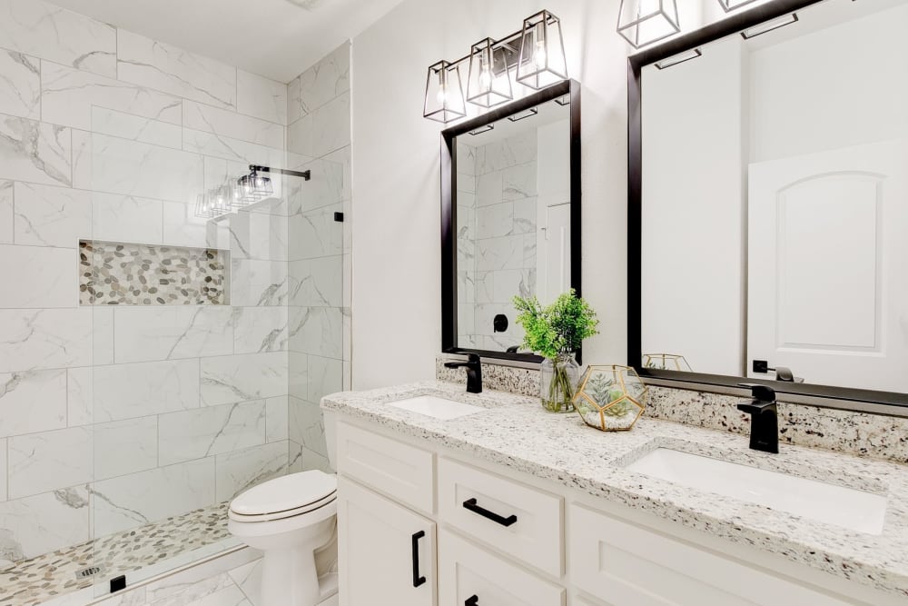 Bathroom with double sink vanity at The Collection Townhomes in Dallas, Texas