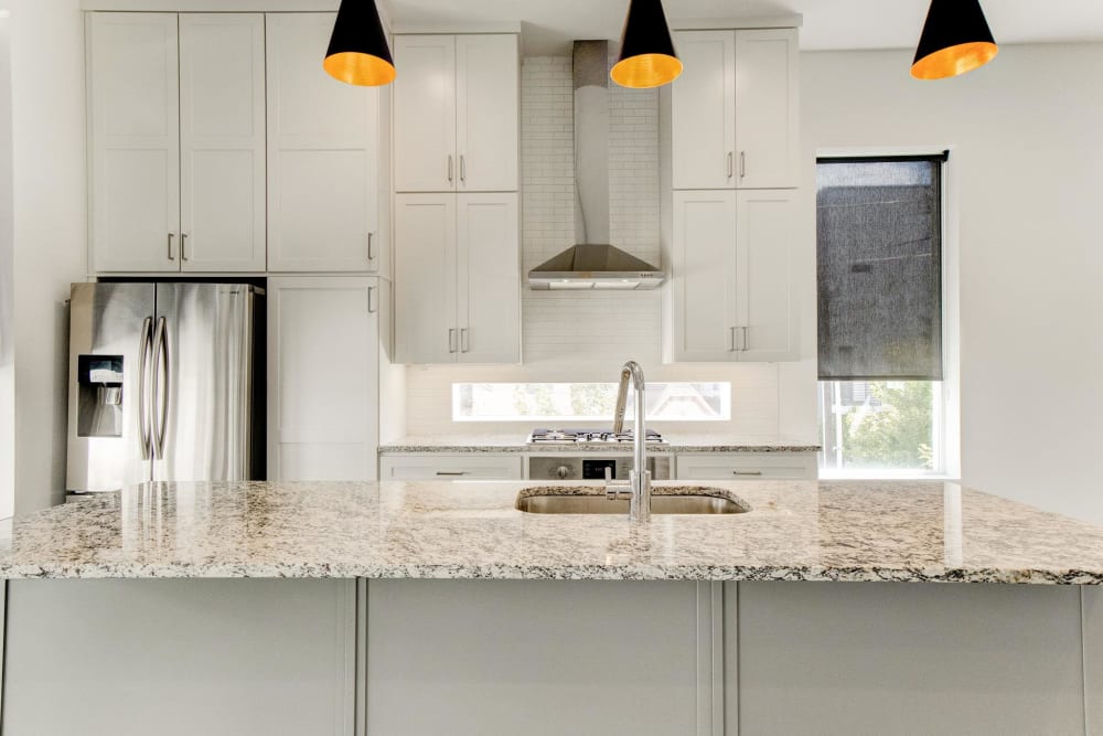 Large kitchen with variety of cabinets and stainless steel fridge at The Collection Townhomes in Dallas, Texas