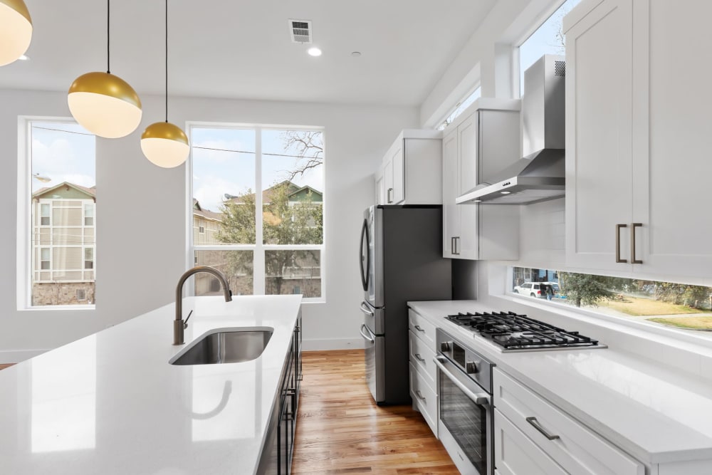 Modern kitchen with marble countertops and stainless steel appliances at The Collection Townhomes in Dallas, Texas