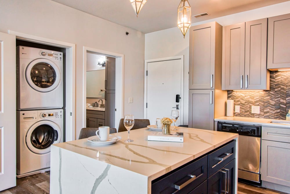 Kitchen island with washer and dryer at Steelyard Apartments