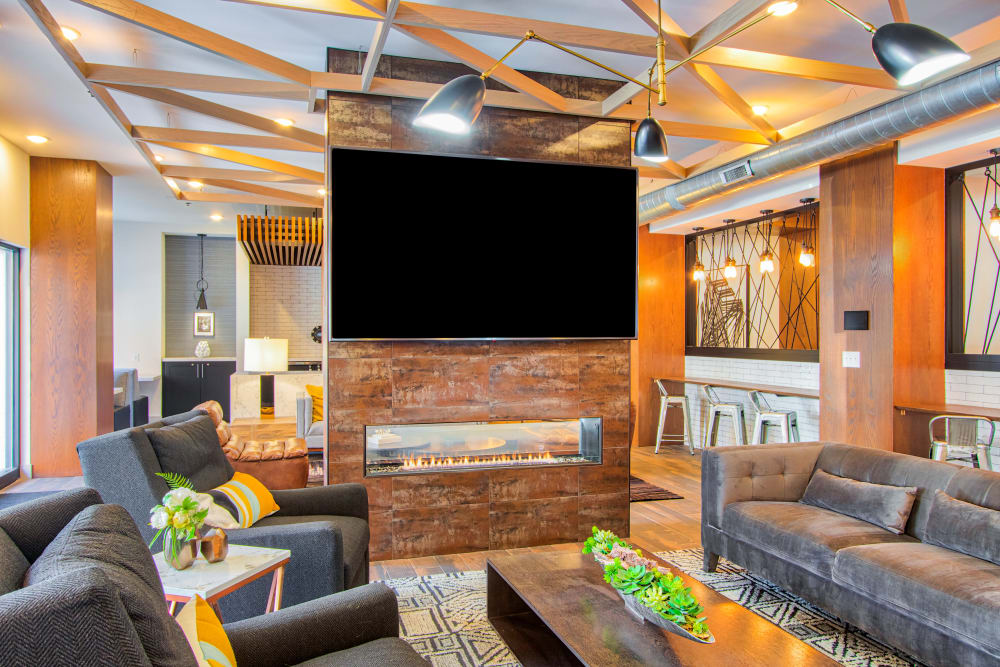 Interior lounge area with TV at Steelyard Apartments in St. Louis, MO