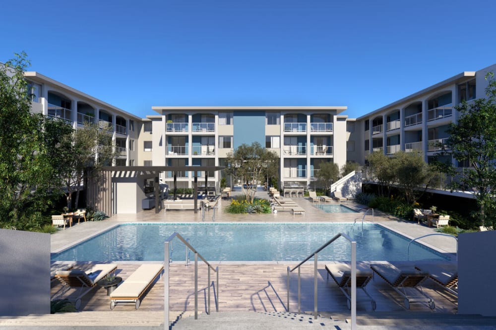The community swimming pool with apartments in the background at Dolphin Marina Apartments in Marina Del Rey, California