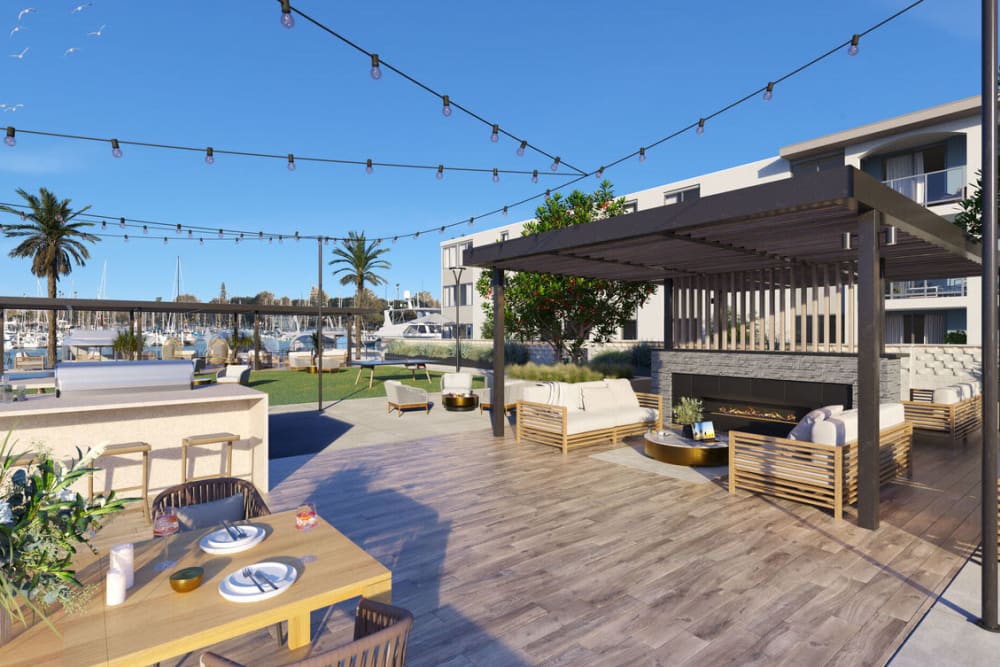 An outdoor community space with seating for residents at Dolphin Marina Apartments in Marina Del Rey, California