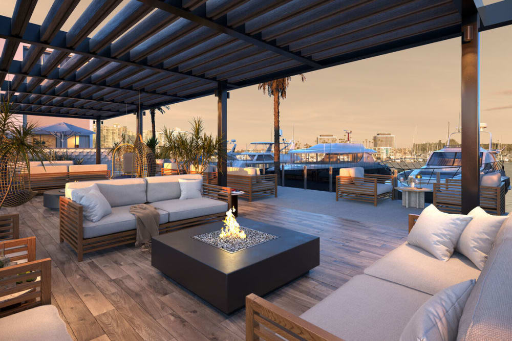 Comfortable lounge seating around an outdoor firepit at Dolphin Marina Apartments in Marina Del Rey, California