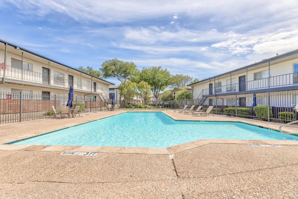 A relaxing swimming pool at Lovato Apartment Homes in Garland, Texas
