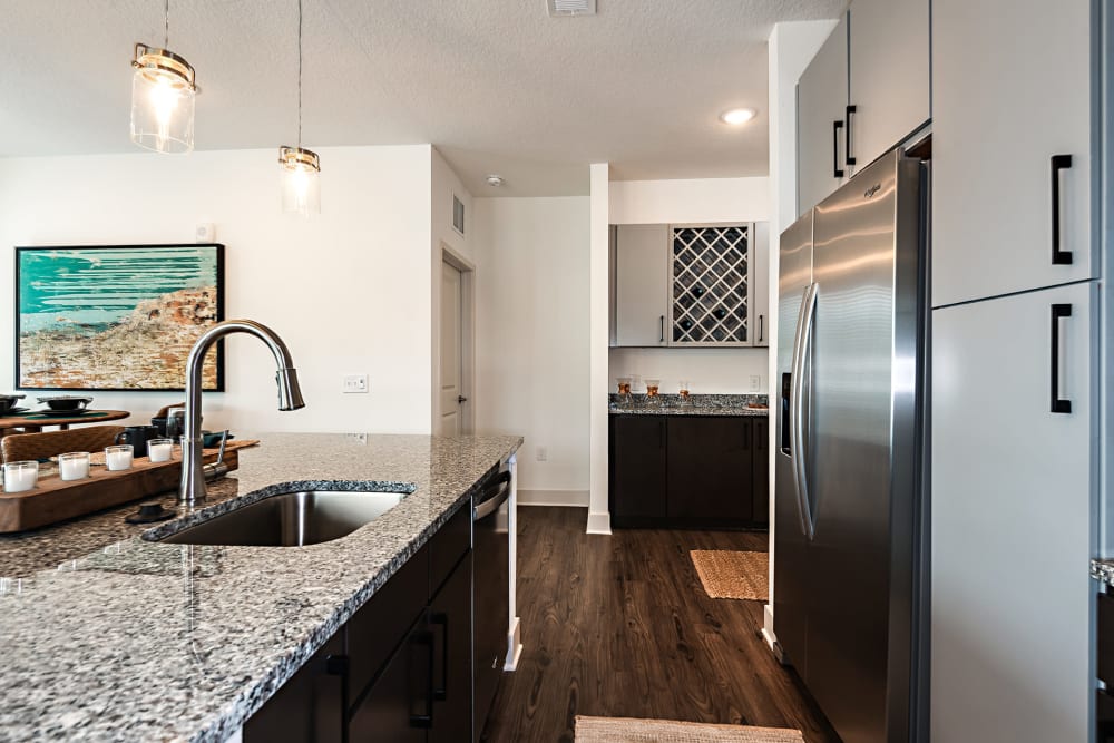 Kitchen with granite countertops at Olympus Preserve at Town Center in Jacksonville, Florida