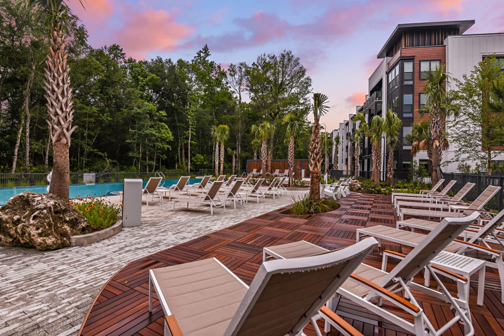 Chaise lounge chairs by the pool at Olympus Preserve at Town Center in Jacksonville, Florida