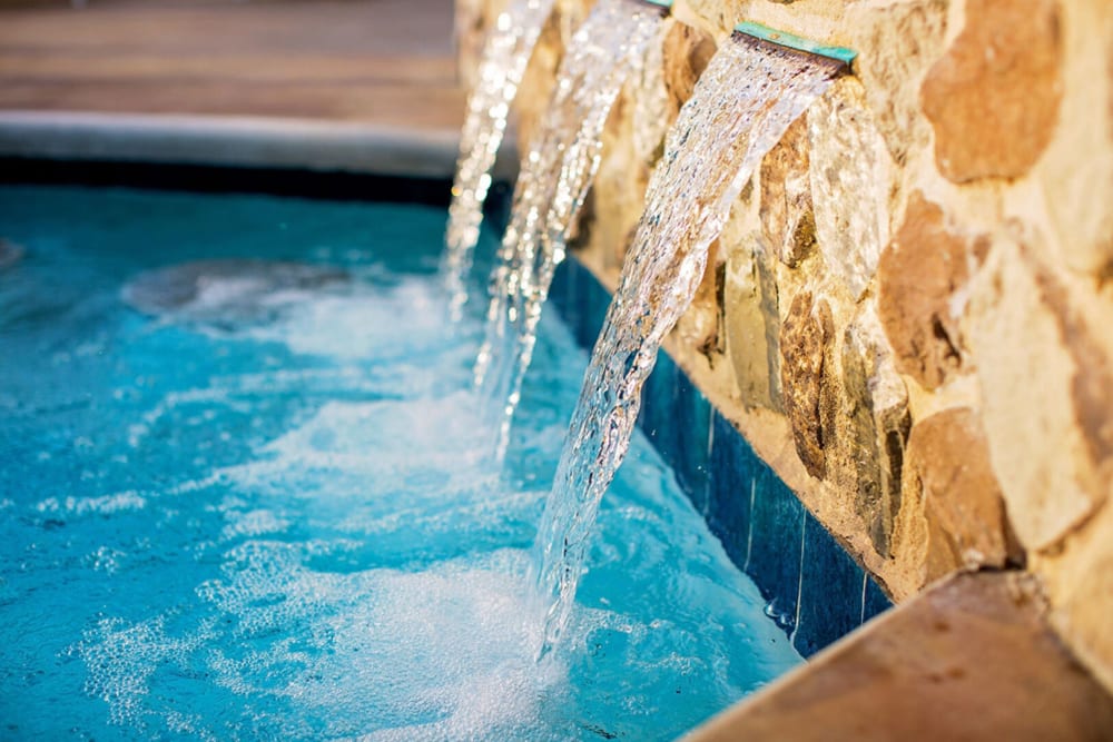 Waterfall feature in our swimming pool at Palisades at Pleasant Crossing in Rogers, Arkansas