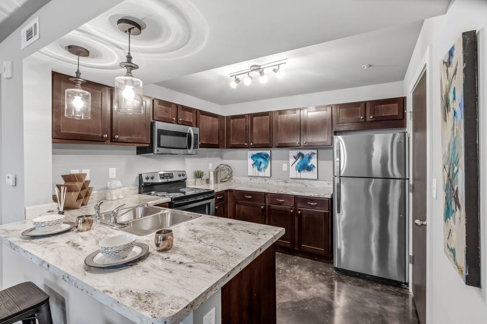 A model kitchen with stainless-steel appliances at Palisades at Pleasant Crossing in Rogers, Arkansas