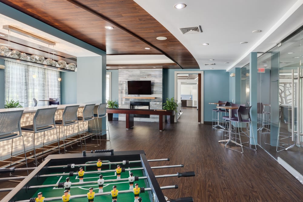 Resident clubhouse with a foosball table at Arcadia at Rivers Edge in Medford, Massachusetts