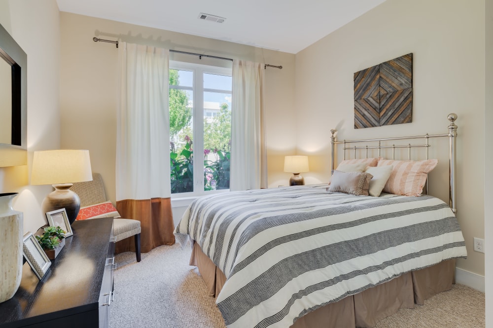 Modern bedroom with soft carpet at Arcadia at Rivers Edge in Medford, Massachusetts