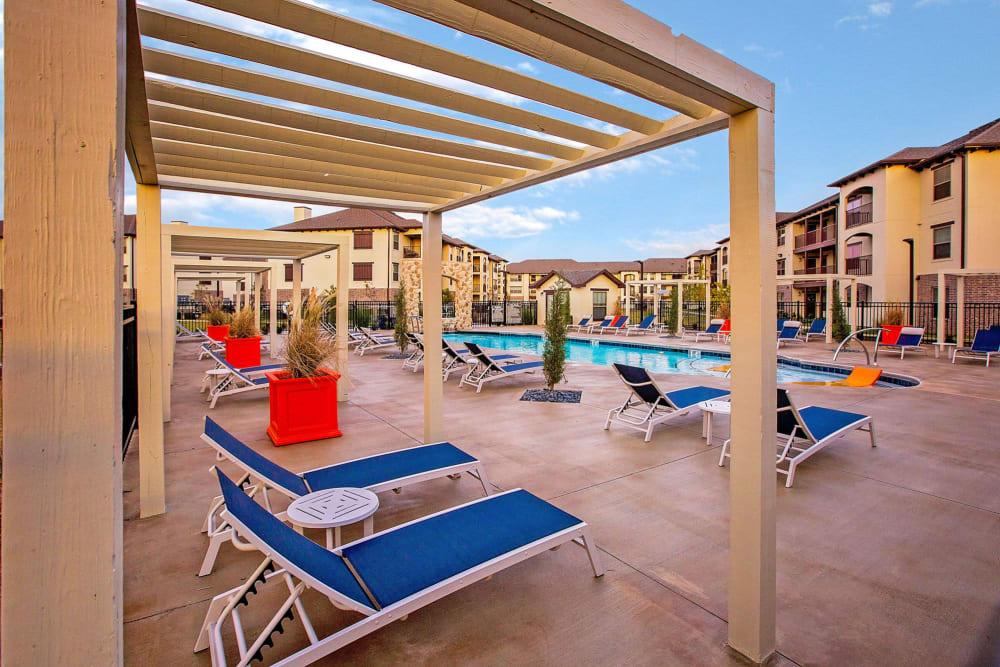 Relax and lounge by our pool at Palisades at Pleasant Crossing in Rogers, Arkansas
