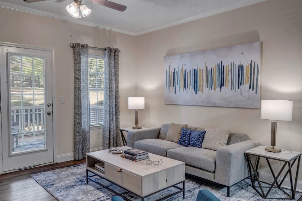 A furnished apartment living room and kitchen at Adrian On Riverside in Macon, Georgia