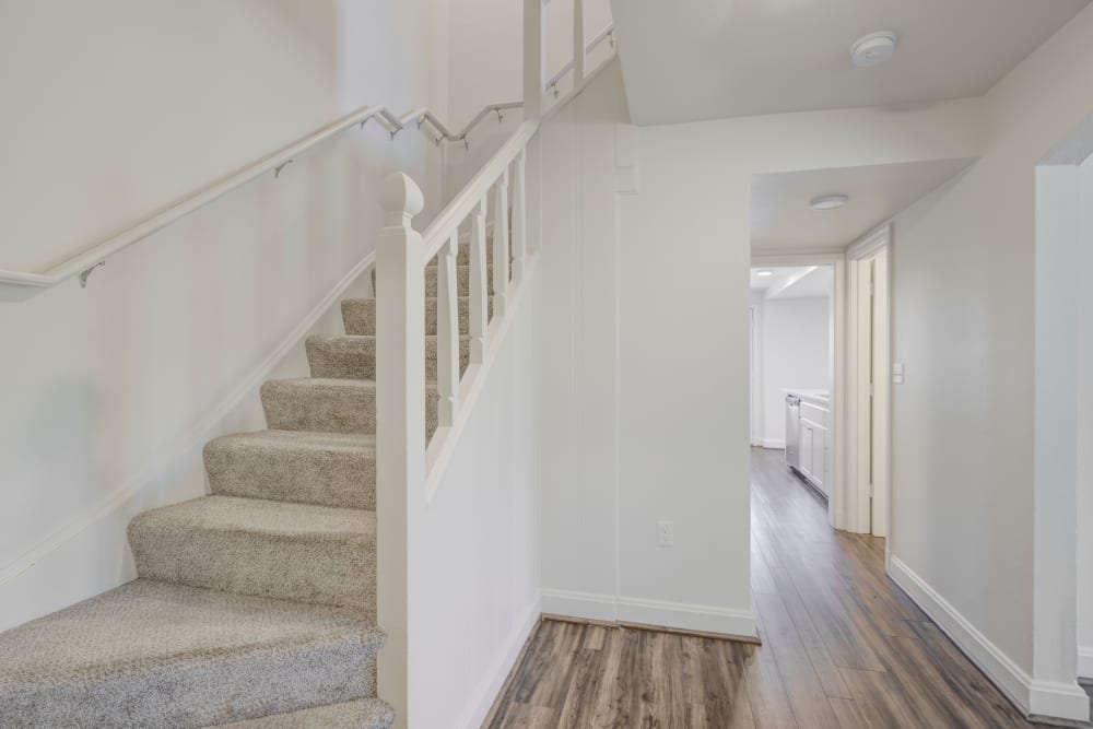 View of hardwood floors on bottom floor and carpet on stairs and upstairs at The Bricks in Joint Base Lewis McChord, Washington