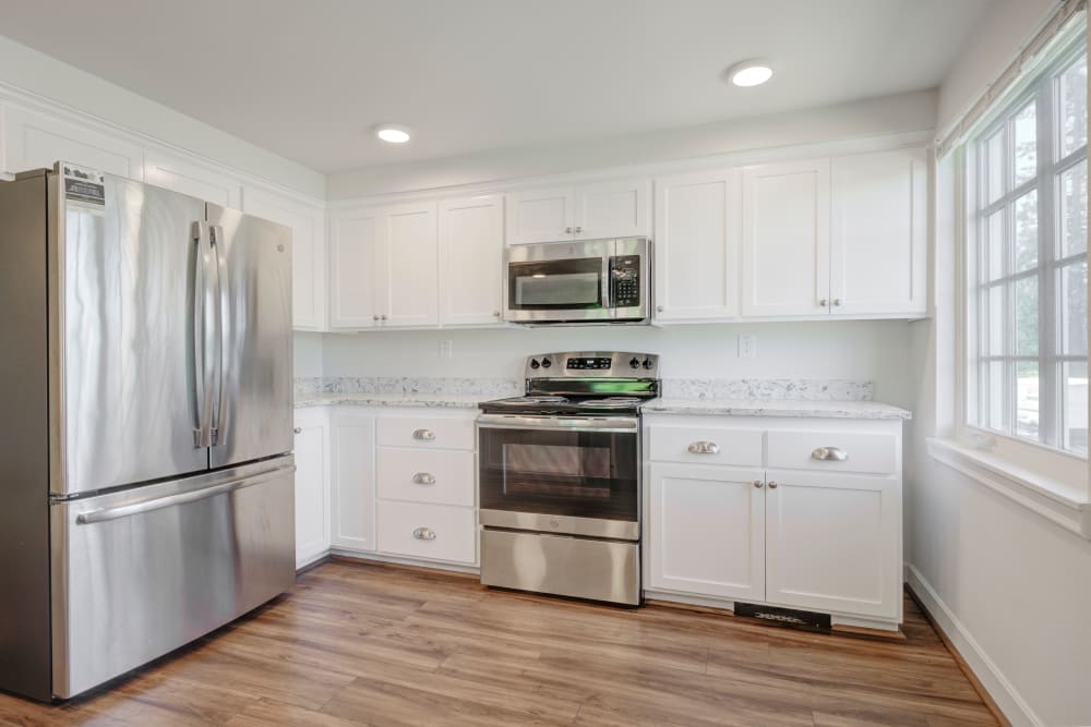 Kitchen with stainless steel appliances and hardwood floors at The Bricks in Joint Base Lewis McChord, Washington