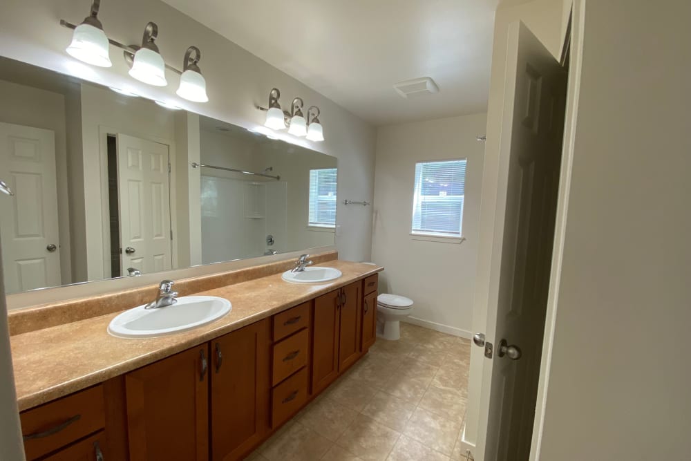 Bathroom with double vanity and walk in shower at Cascade Village in Joint Base Lewis McChord, Washington