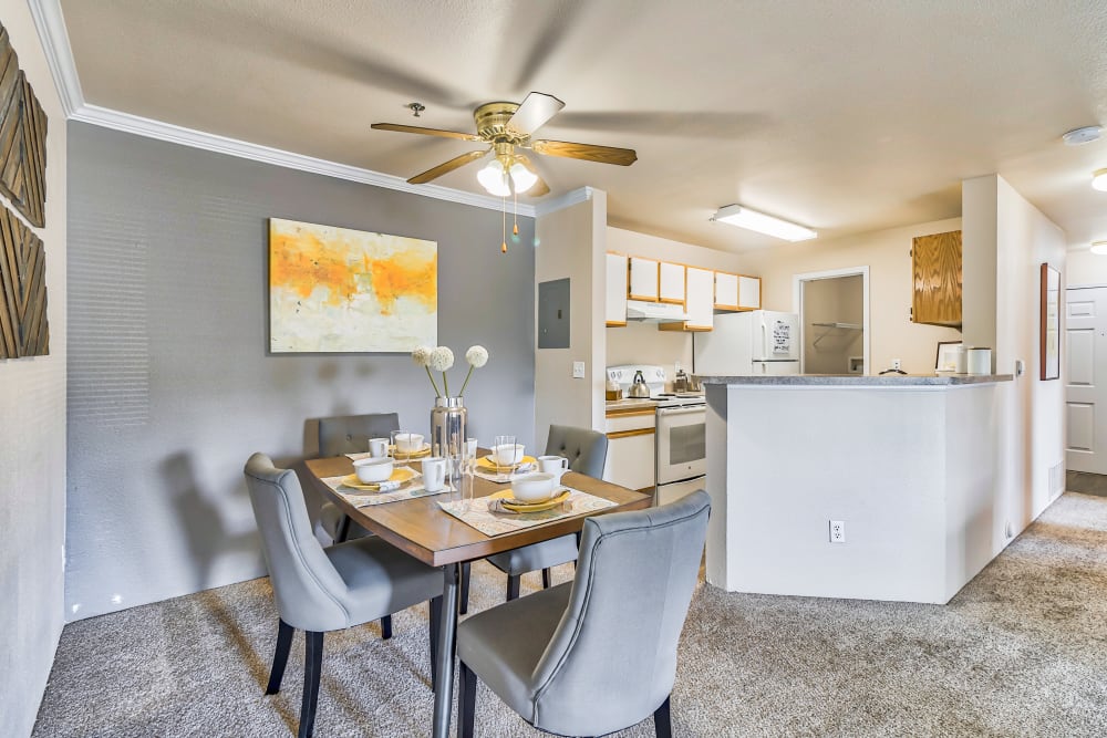 Dining area off of kitchen with ceiling fan at The Pines at Castle Rock Apartments in Castle Rock, Colorado