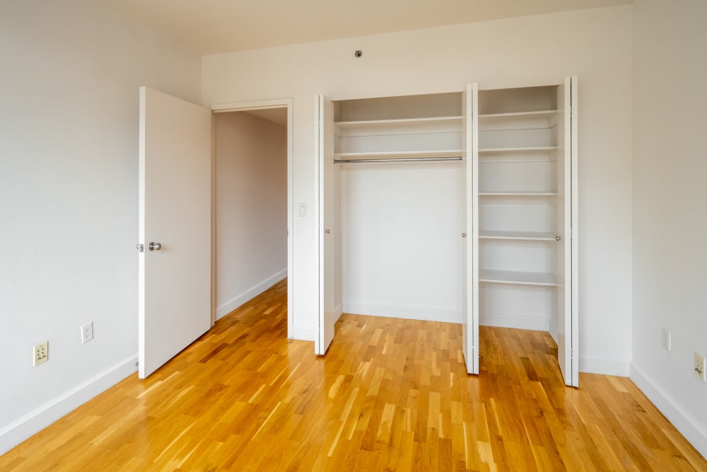 Bedroom with large closet and plank flooring at The Sierra Chelsea in New York, New York