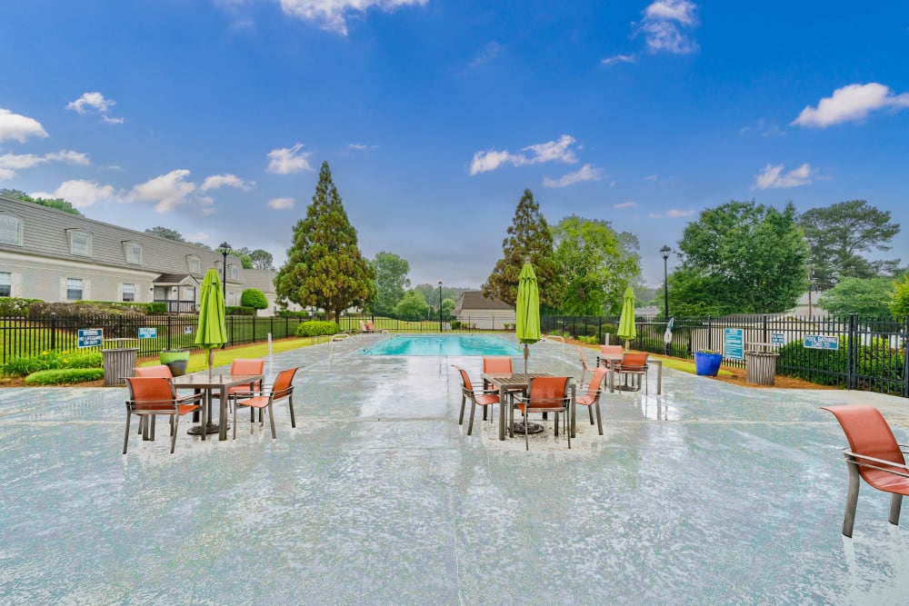 Poolside patio with picnic tables at ibex Park in Smyrna, Georgia