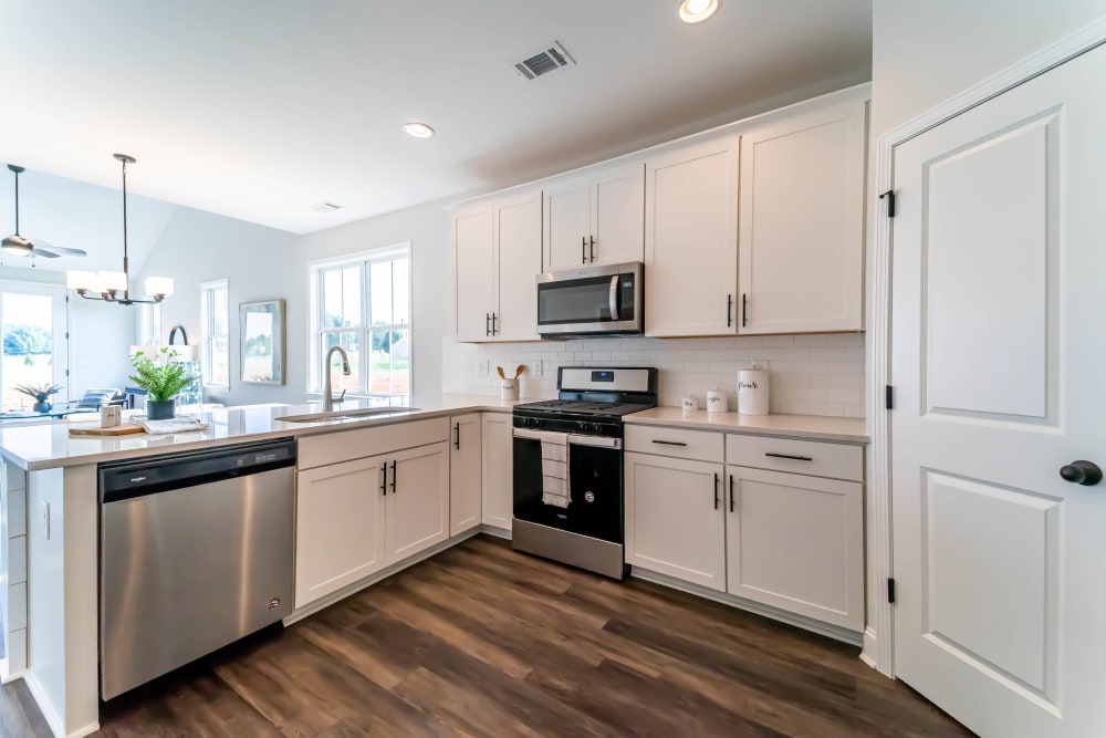 Townhome kitchen with hardwood floors and stainless steel appliances at Baldwin Chase in Mauldin, South Carolina