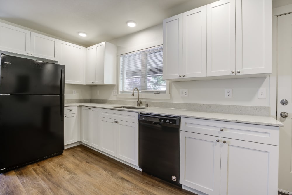 Updated kitchen with quartz countertops and black appliances at Heartwood in Joint Base Lewis McChord, Washington